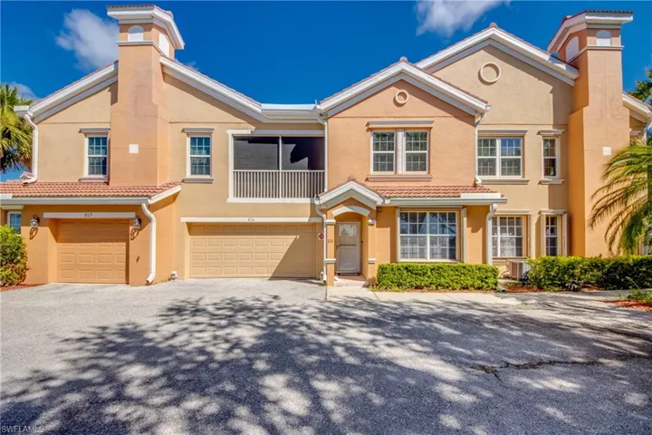 Mediterranean / spanish-style home featuring stucco siding, driveway, a garage, and a chimney