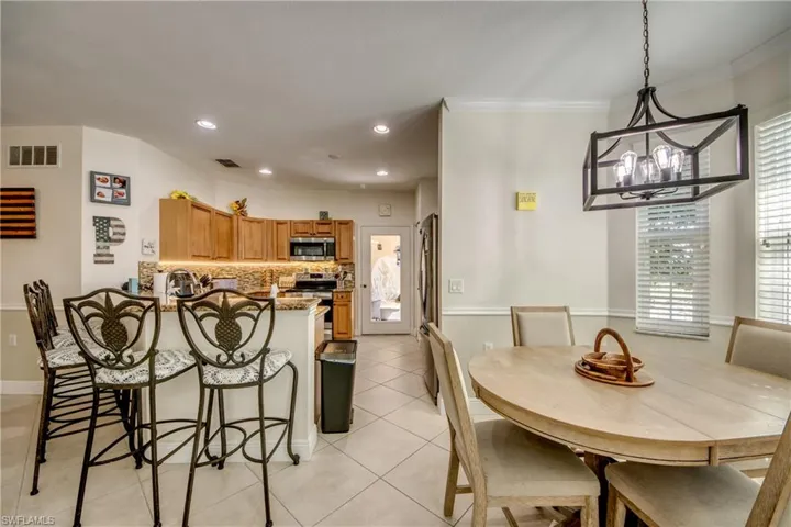 Dining room featuring light tile patterned floors and recessed lighting