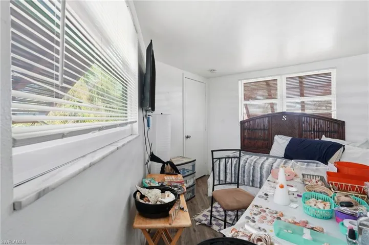 Bedroom featuring wood finished floors - Virtually Edited Image