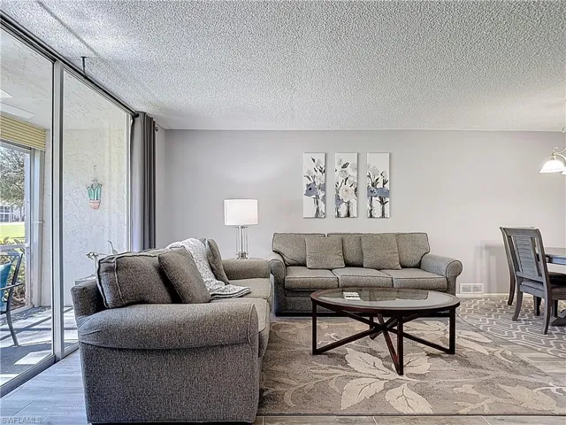 Living area featuring a textured ceiling and wood finished floors