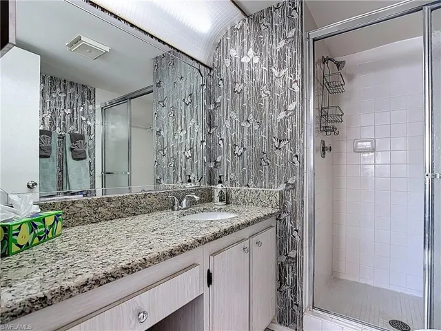 Bathroom with vanity and a shower stall
