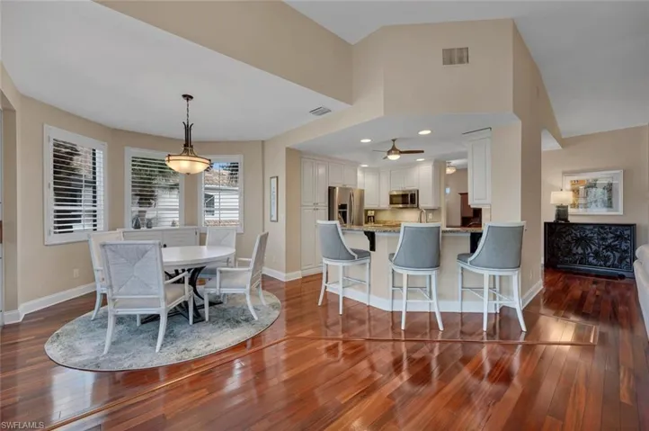 Dining space with dark hardwood / wood-style floors and ceiling fan