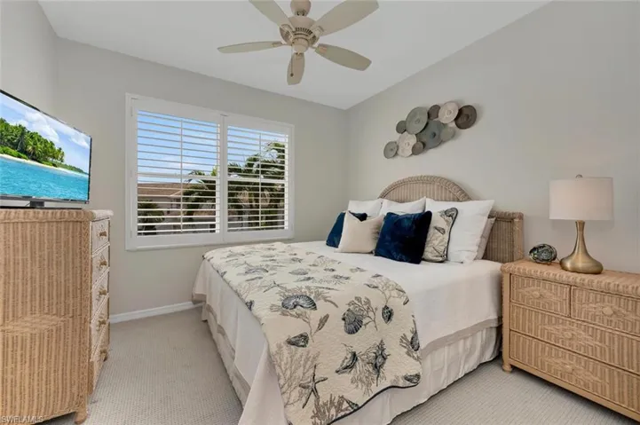 Bedroom with light carpet and ceiling fan
