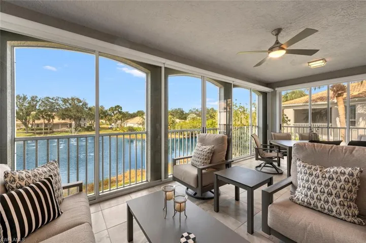 Sunroom featuring a water view and ceiling fan