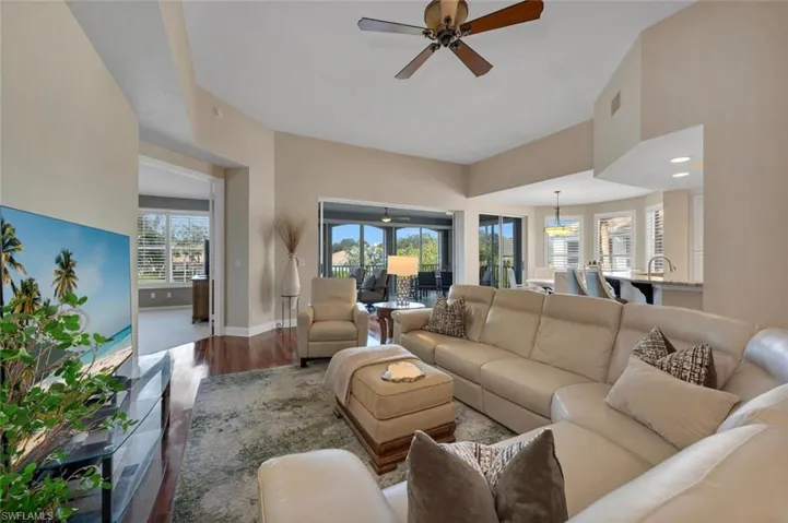 Living room with plenty of natural light, ceiling fan, and wood-type flooring