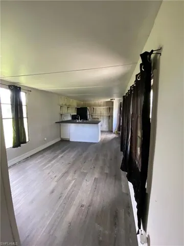 Unfurnished living room featuring hardwood / wood-style flooring