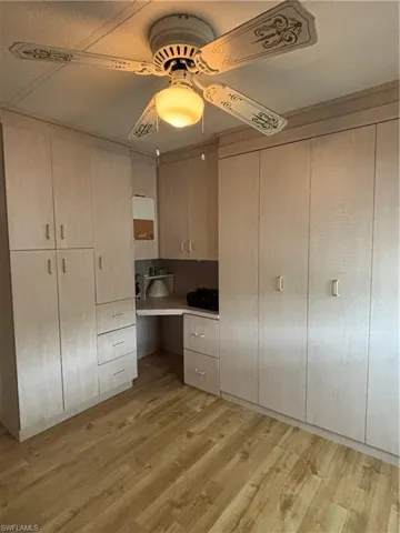 Guest bedroom with cabinets a Murphy bed and closet