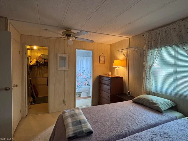Bedroom featuring carpet, a spacious closet, a closet, and connected bathroom