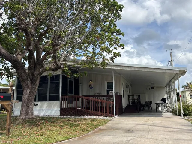 Manufactured / mobile home featuring an attached carport and concrete driveway