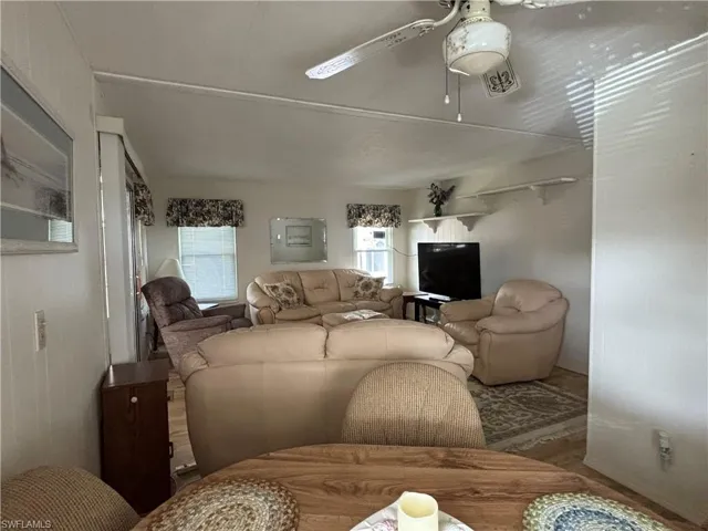 Living room featuring wood finished floors and ceiling fan