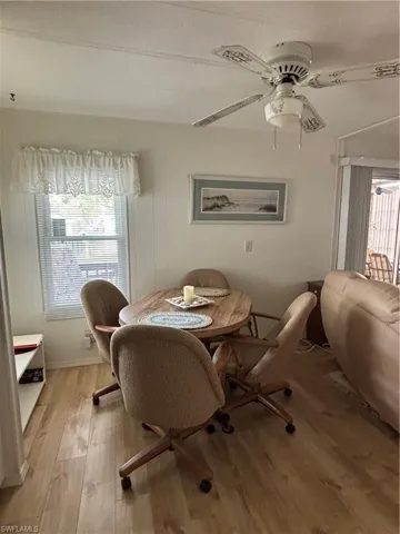 Dining area featuring light wood finished floors, a healthy amount of sunlight, and a ceiling fan
