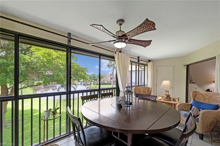 Sunroom / solarium featuring a water view