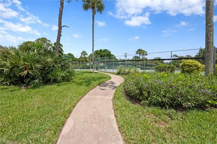 View of home's community featuring a tennis court