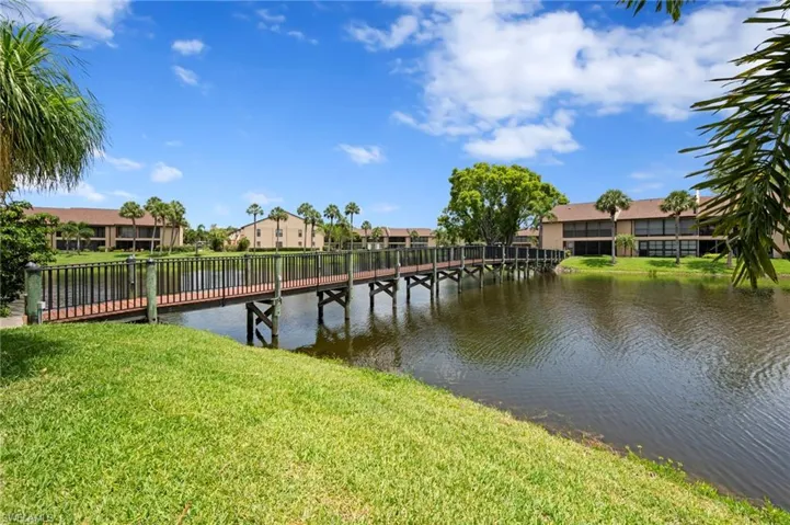 Dock area featuring a lawn, a water view, and a residential view