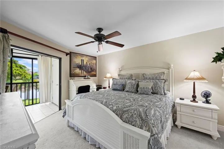 Bedroom with access to outside, carpet floors, and a ceiling fan