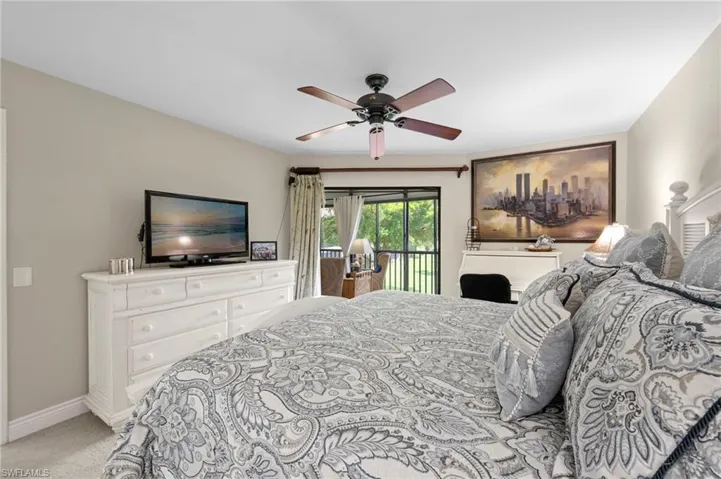 Bedroom with access to exterior, light carpet, baseboards, and ceiling fan