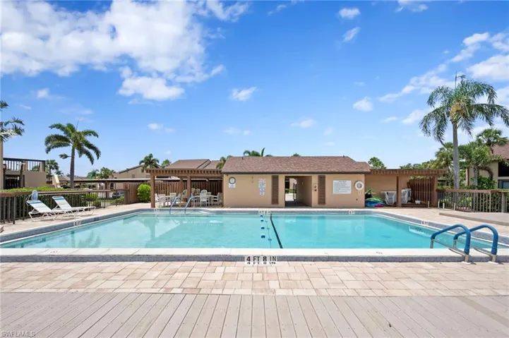 Community pool with a patio