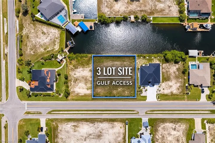 Aerial view of residential area featuring a large body of water