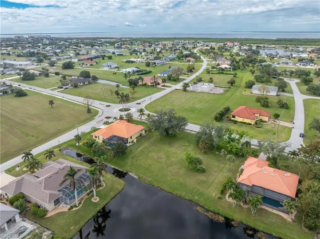 Aerial view featuring a residential view and a water view