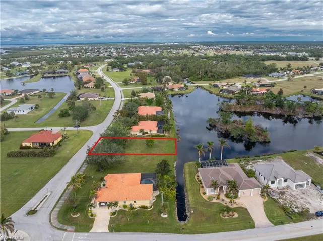 Drone / aerial view with a residential view and a water view