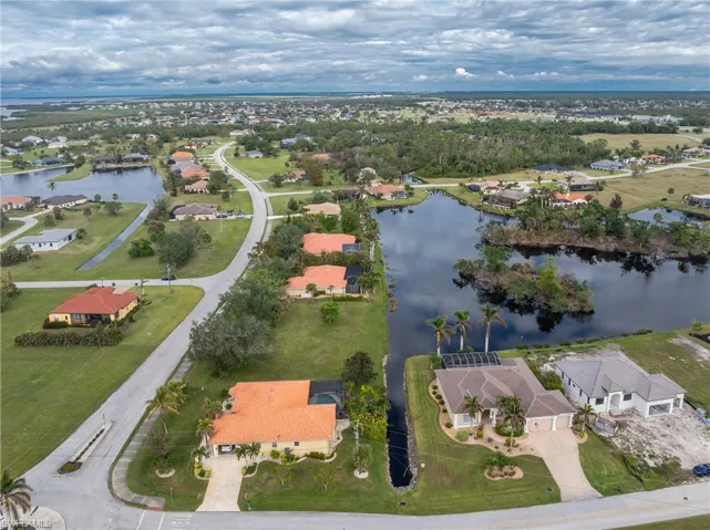 Drone / aerial view with a residential view and a water view