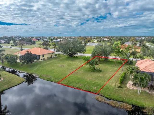 Birds eye view of property with a water view