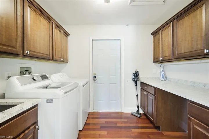 Lovely laundry room with sink, storage and folding counter
