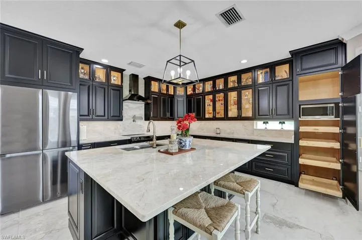 Gourmet Kitchen with cabinets lit and all the way to the ceiling.  NOTICE.....all shelving beneath the microwave are "pull out" shelves for easy access to your items.