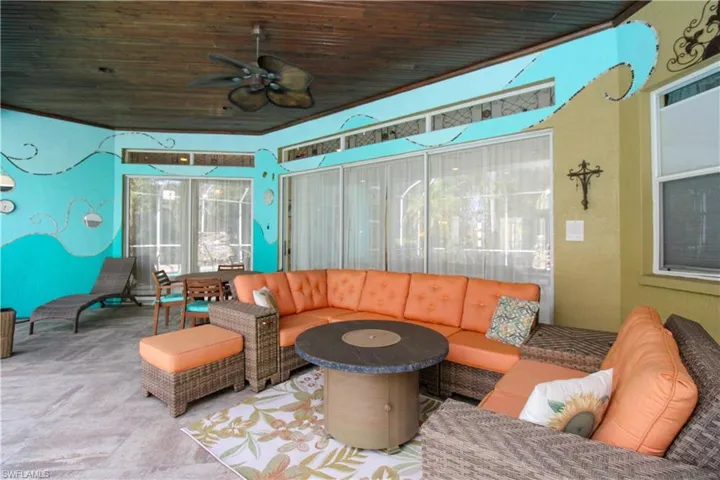 Sunroom / solarium featuring ceiling fan and wood ceiling