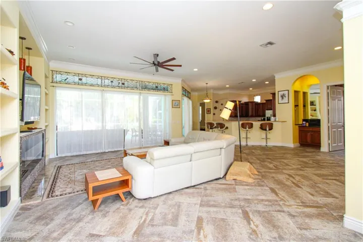 Living room with ceiling fan and crown molding