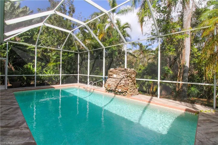 View of swimming pool with a patio area and a lanai
