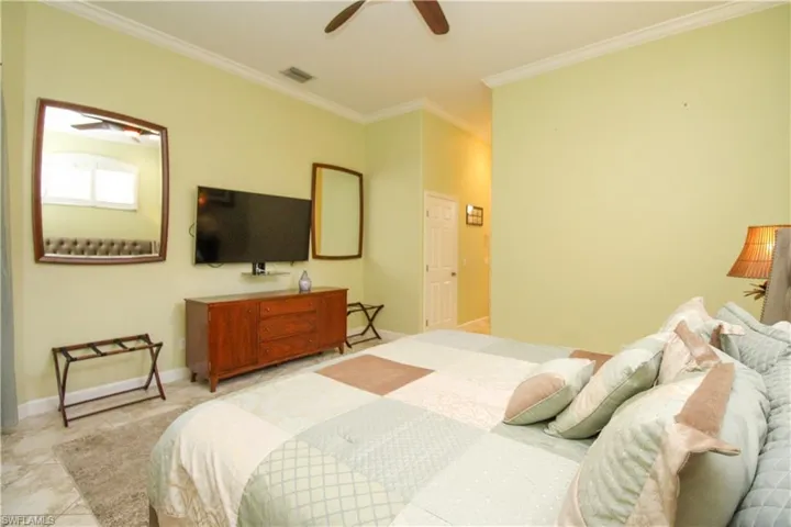 Bedroom featuring ceiling fan and crown molding