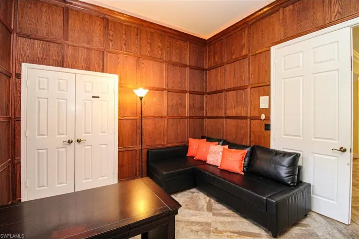 Unfurnished living room with wood walls