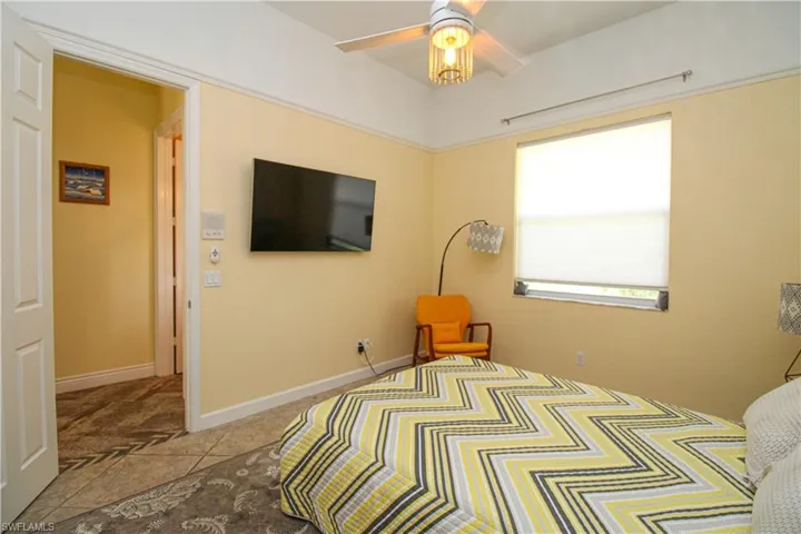 Bedroom featuring ceiling fan and light tile patterned flooring