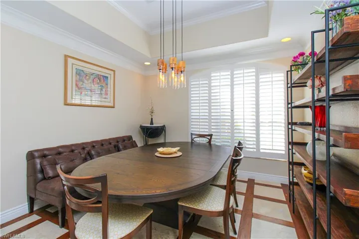 Dining space with a chandelier and ornamental molding