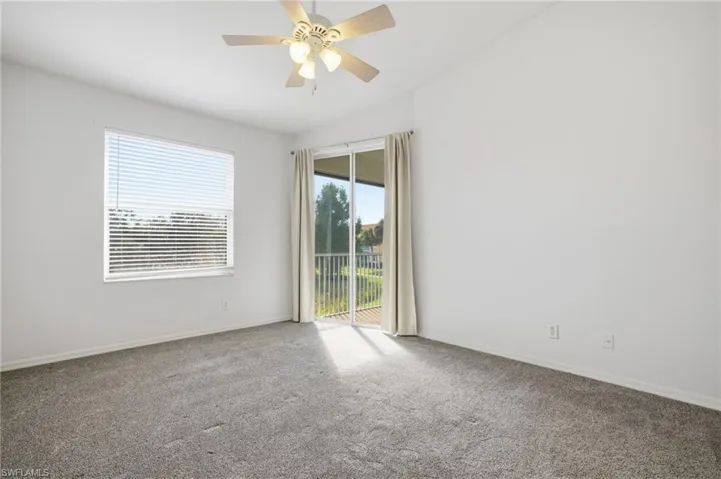 Newer carpet, lighted ceiling fan, and vaulted ceiling
