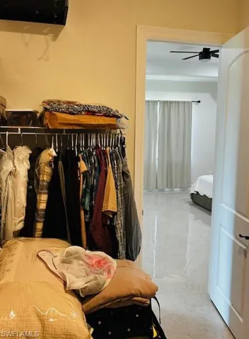 Walk in closet with ceiling fan