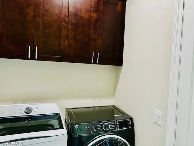 Laundry area with cabinet space and independent washer and dryer