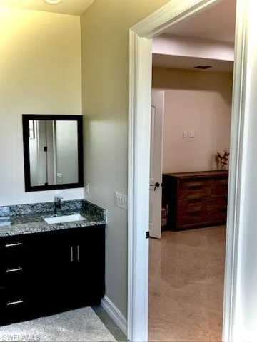 Bathroom featuring vanity and baseboards