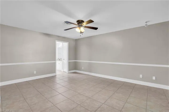 Tiled spare room with ceiling fan