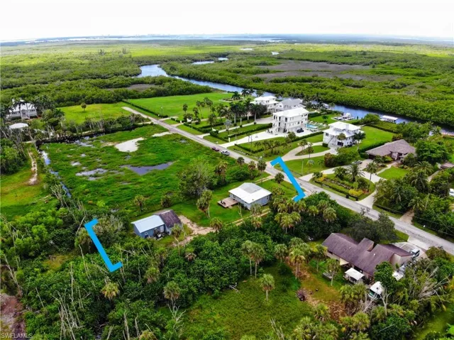 Bird's eye view of a nearby body of water and a heavily wooded area