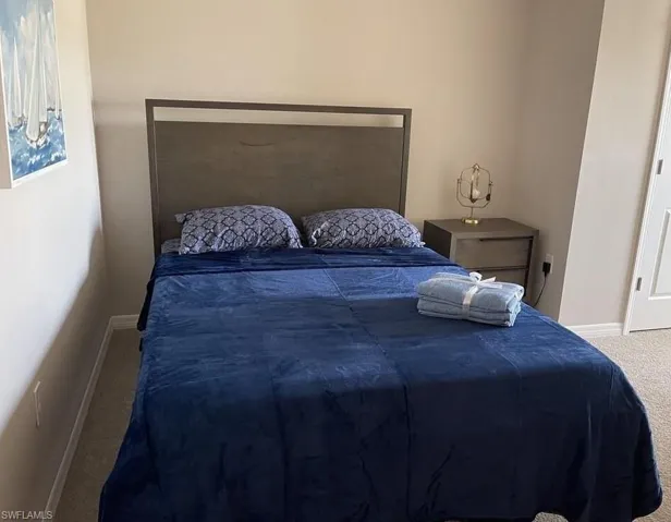 Carpeted bedroom with baseboards