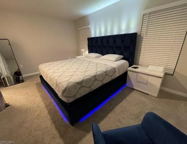 Carpeted bedroom with baseboards