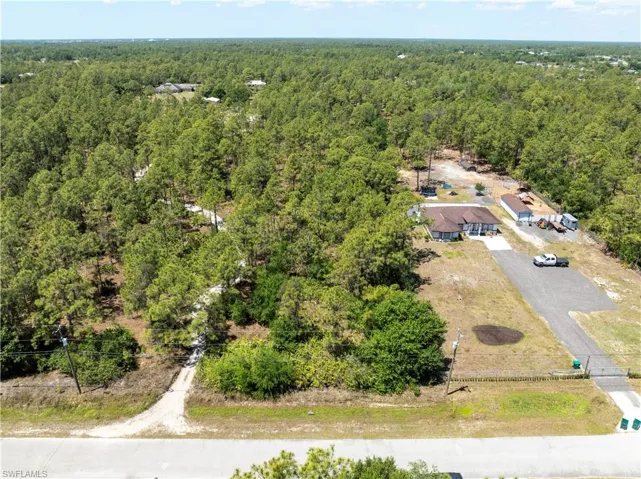 Aerial view featuring a wooded view