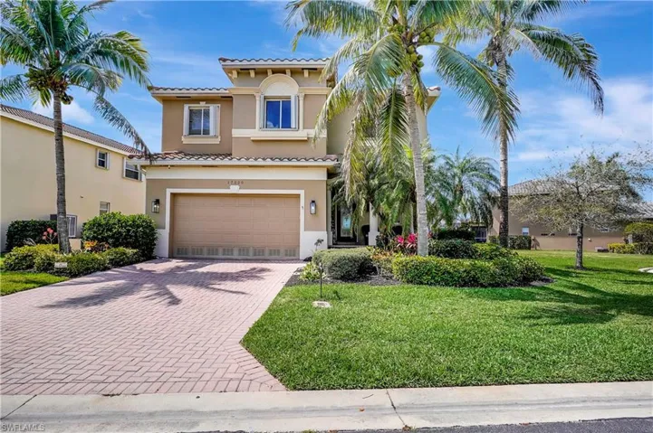 Mediterranean / spanish-style house with stucco siding, an attached garage, decorative driveway, and a tiled roof
