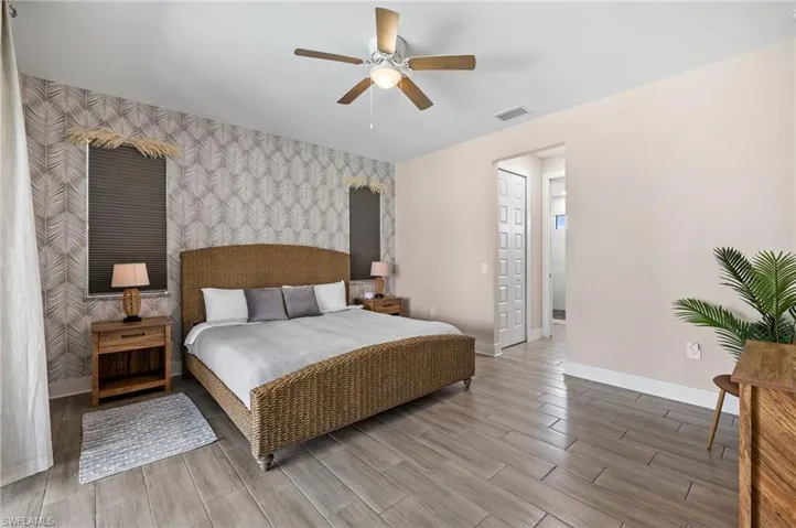 Master/ Primary Suite with patio door to the pool area.