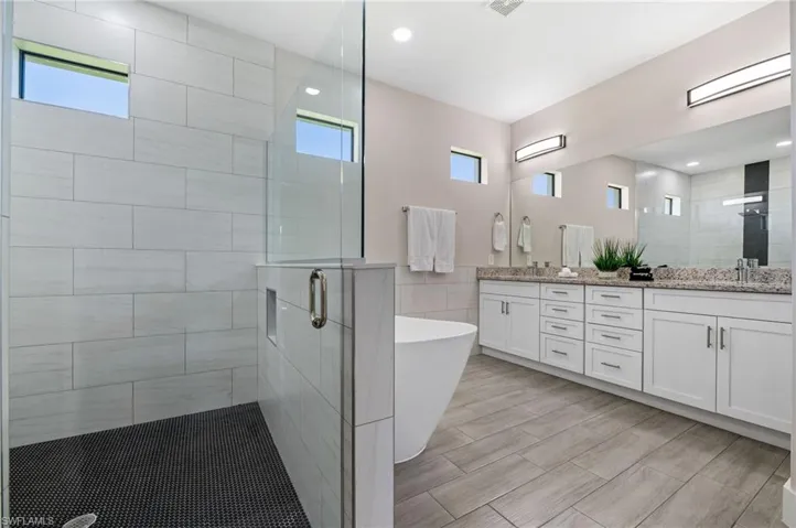 Master Bathroom with Walk-in shower, tub and dual sinks.