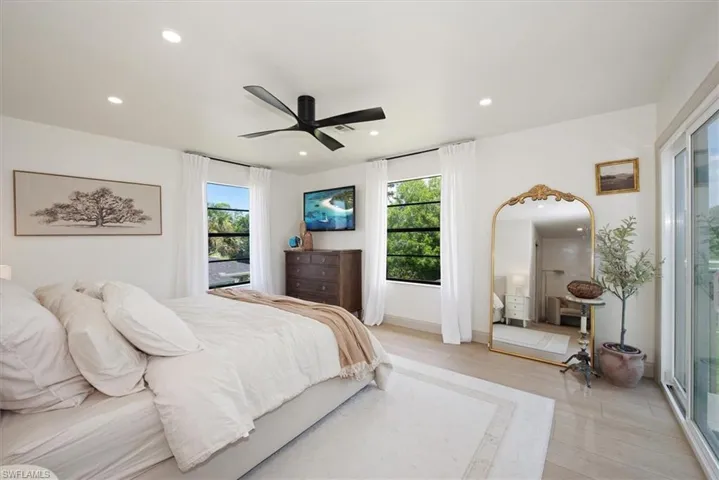 Bedroom featuring ceiling fan, access to exterior, recessed lighting, and ensuite bathroom