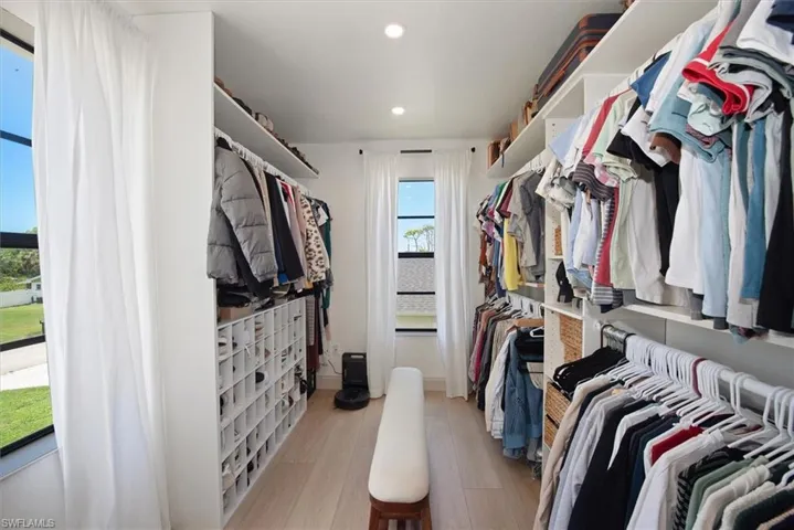Bedroom featuring recessed lighting, ornamental molding, and light wood-style floors
