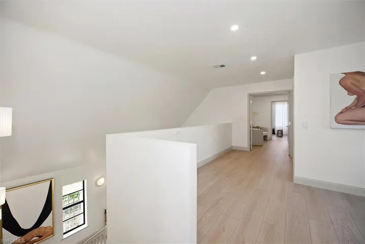 Hall featuring light wood-type flooring, recessed lighting, and french doors